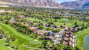 Drone / aerial view with a water and mountain view and Golf Course