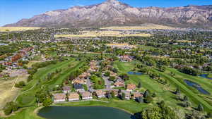 Birds eye view of property with a water and mountain view and Golf Course