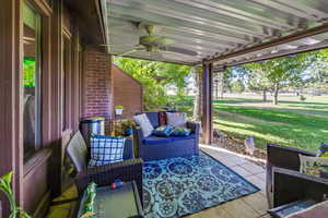 View of patio / terrace with ceiling fan and an outdoor living space