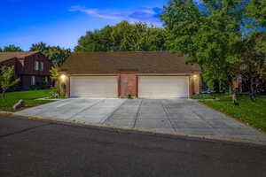 View of front facade featuring a front yard and a garage