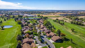 Birds eye view of property with a water view and Golf Course