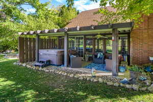 View of patio / terrace with a hot tub