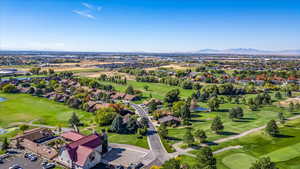 Birds eye view of property with a mountain view and Golf Course