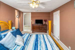 Bedroom with light colored carpet and ceiling fan