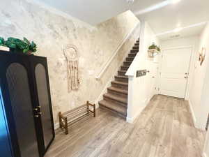 Entrance foyer featuring light hardwood / wood-style flooring