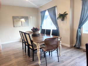 Dining room with light hardwood / wood-style floors and a wealth of natural light