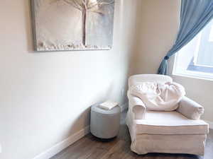 Living area with hardwood / wood-style flooring and plenty of natural light