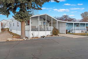 Manufactured / mobile home featuring a carport and covered porch