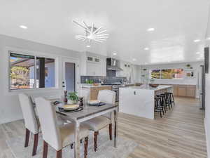 Dining space featuring light hardwood / wood-style flooring and an inviting chandelier