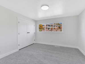 Unfurnished room featuring light colored carpet