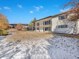 Snow covered property featuring a balcony