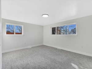 Unfurnished room featuring carpet flooring