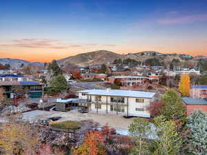 Back house at dusk with a mountain view and a balcony