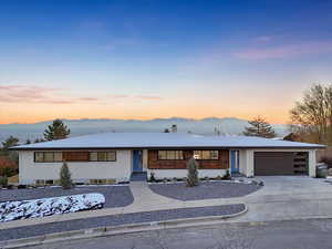 View of front facade featuring a mountain view and a garage