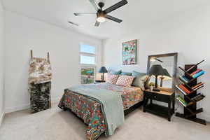 Bedroom featuring light colored carpet and ceiling fan