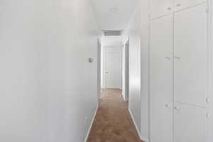 Hallway with light colored carpet