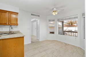 Kitchen featuring ceiling fan and sink