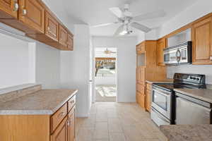 Kitchen with ceiling fan and stainless steel appliances