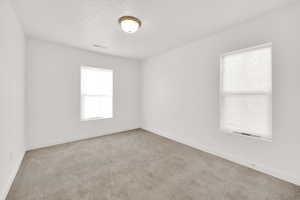 Spare room featuring light colored carpet