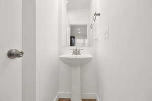 Bathroom featuring wood-type flooring and sink