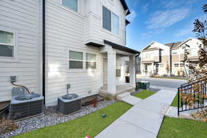 Entrance to property featuring central AC unit