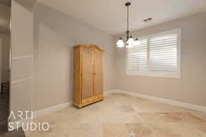 Formal dining room with a notable chandelier