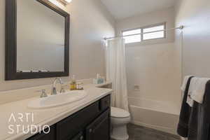 Hall bathroom with vanity, toilet, and shower / tub combo with curtain