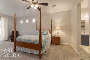 Huge primary bedroom featuring connected bathroom, ceiling fan, and sink