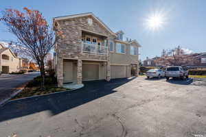 View of front of house featuring a balcony and a garage