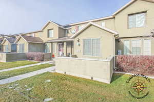 View of front of home with a front yard and patio