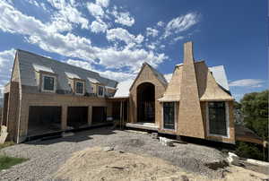 View of front of property featuring solar panels