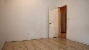 Unfurnished room featuring light tile patterned flooring