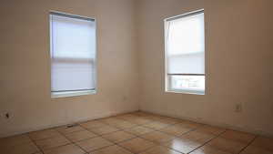 Empty room featuring light tile patterned floors