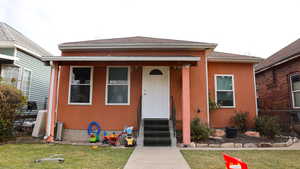 Bungalow-style house featuring a front yard