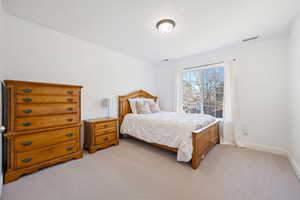 Bedroom with light colored carpet