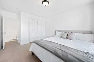 Bedroom featuring light carpet