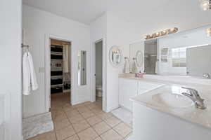 Bathroom with tile patterned floors, vanity, and toilet