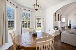 Dining space with dark hardwood / wood-style floors and a healthy amount of sunlight