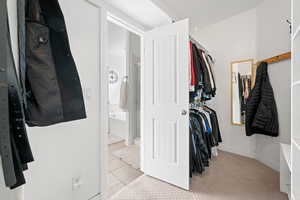 Walk in closet featuring light tile patterned flooring