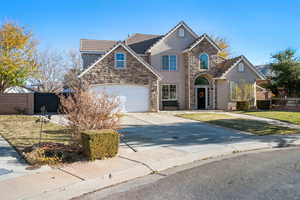 Front of property with a garage and a front lawn