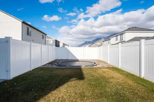 View of yard featuring an in ground trampoline