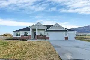 Craftsman-style home with a mountain view, a garage, and a front lawn