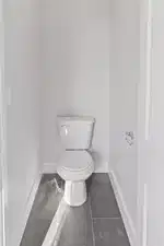 Bathroom featuring tile patterned flooring and toilet