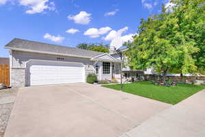 View of front facade with a front yard and a garage