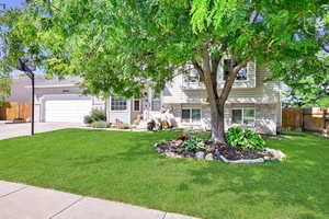 Tri-level home with a front yard and a garage