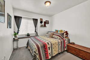 Carpeted bedroom featuring a charming window seat