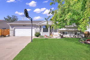 View of front of home featuring a garage and a front lawn