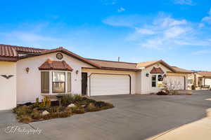 Mediterranean / spanish-style home featuring a garage