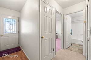 Entrance foyer featuring a textured ceiling and light hardwood / wood-style flooring