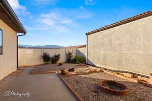 View of yard with a mountain view and a patio area